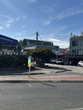 Streetscape with "Keep Left" sign and prism visible in it